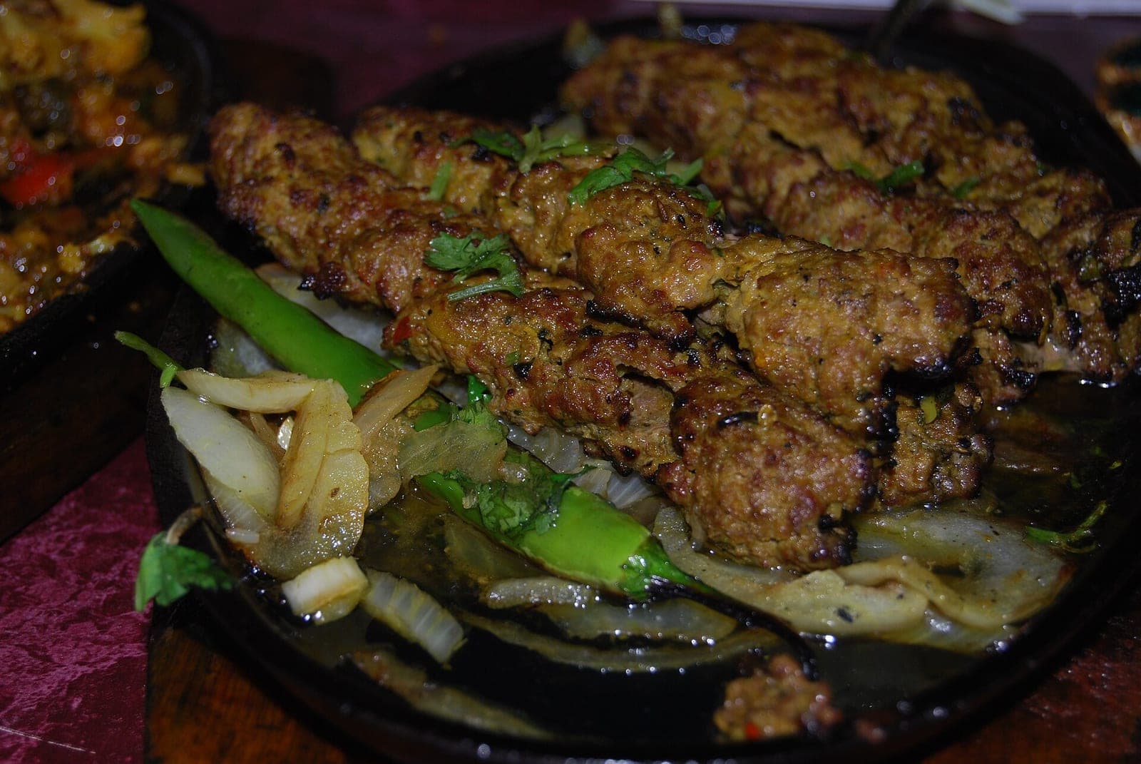 Seekh kebabs served with onions and lemon