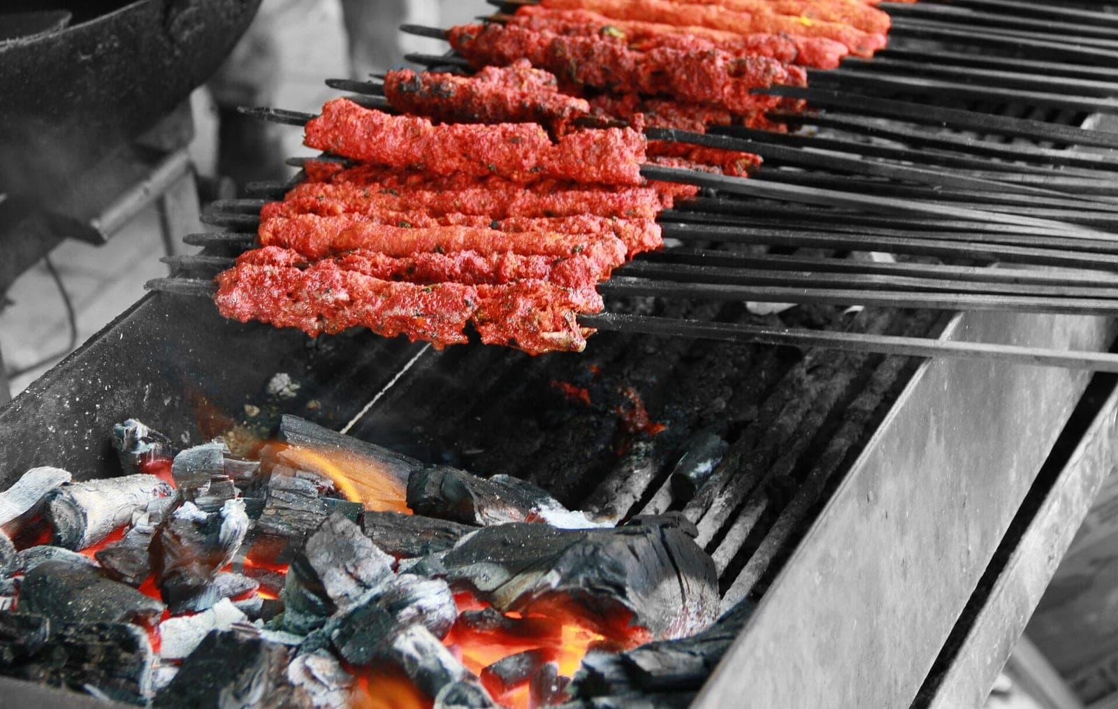 Seekh kebabs on skewers over the grill