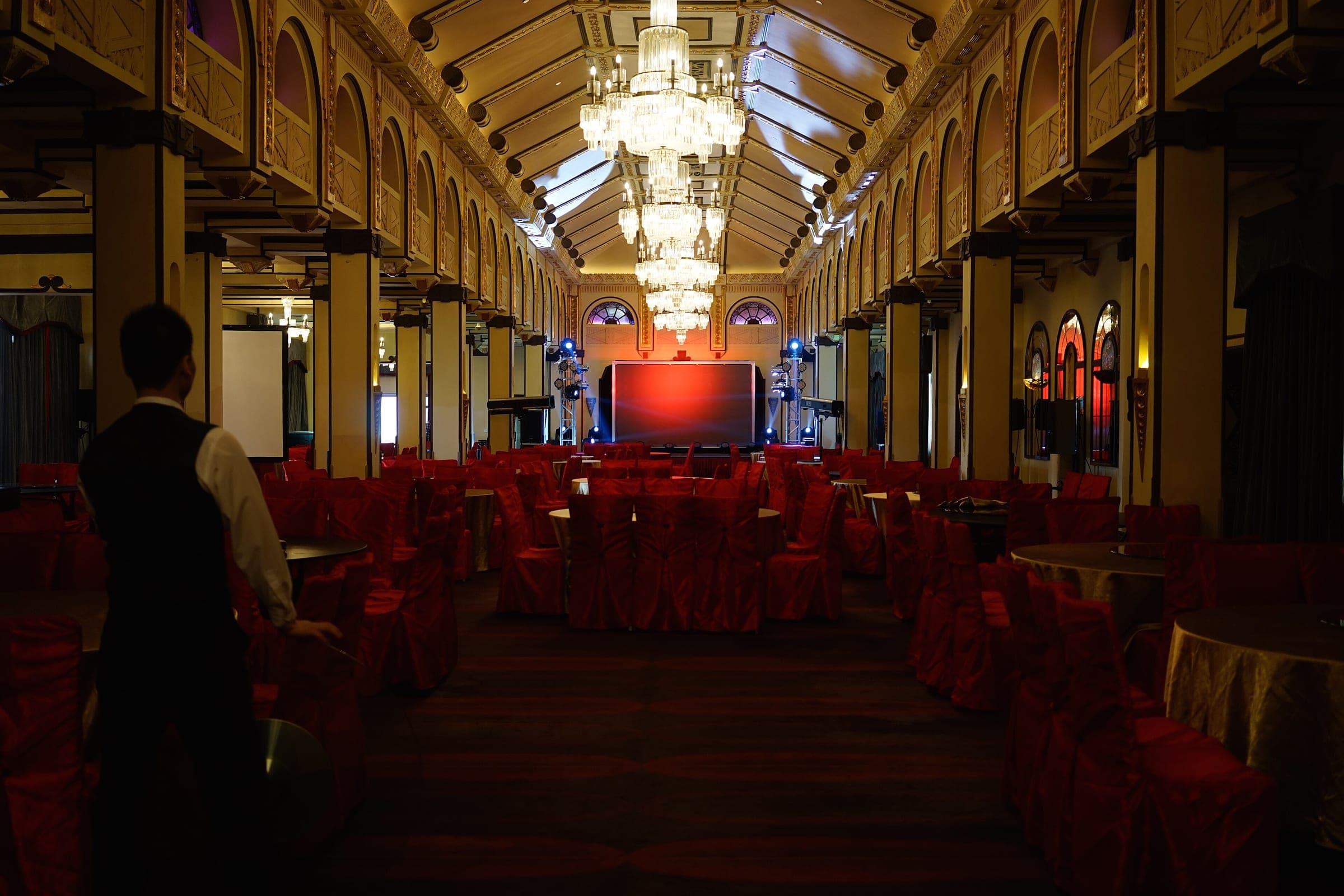 Banquet hall set with round tables and chandeliers