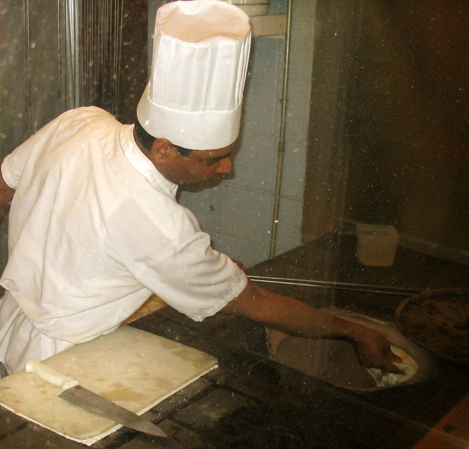 Chef preparing bread at the tandoor
